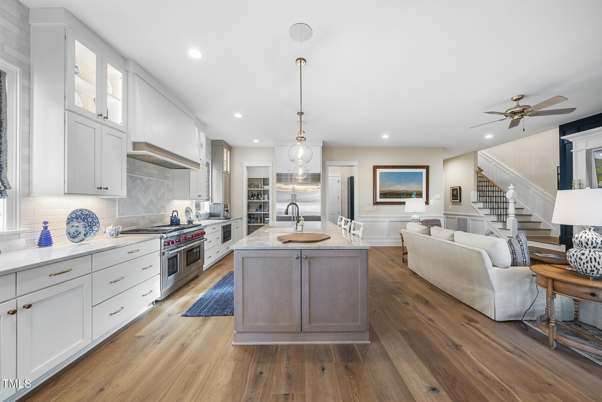 3018 Farrior Road Raleigh, NC 27607 - Photo 17 of 59 a large kitchen with white cabinets and stainless steel appliances