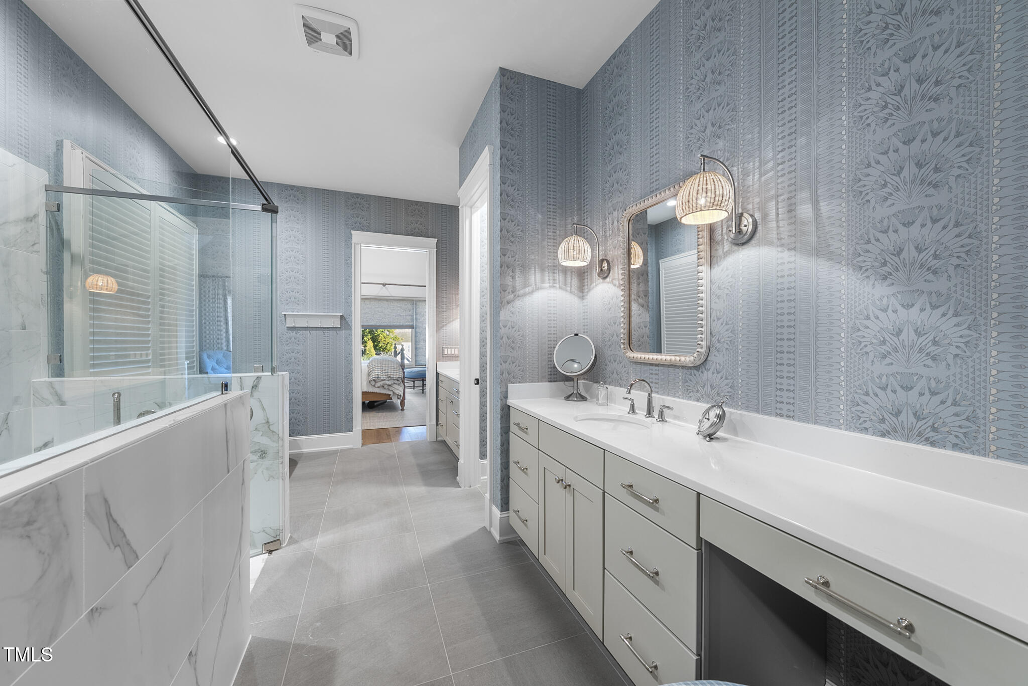 3018 Farrior Road Raleigh, NC 27607 - Photo 23 of 59 a spacious bathroom with a double vanity sink a large mirror and a bathtub