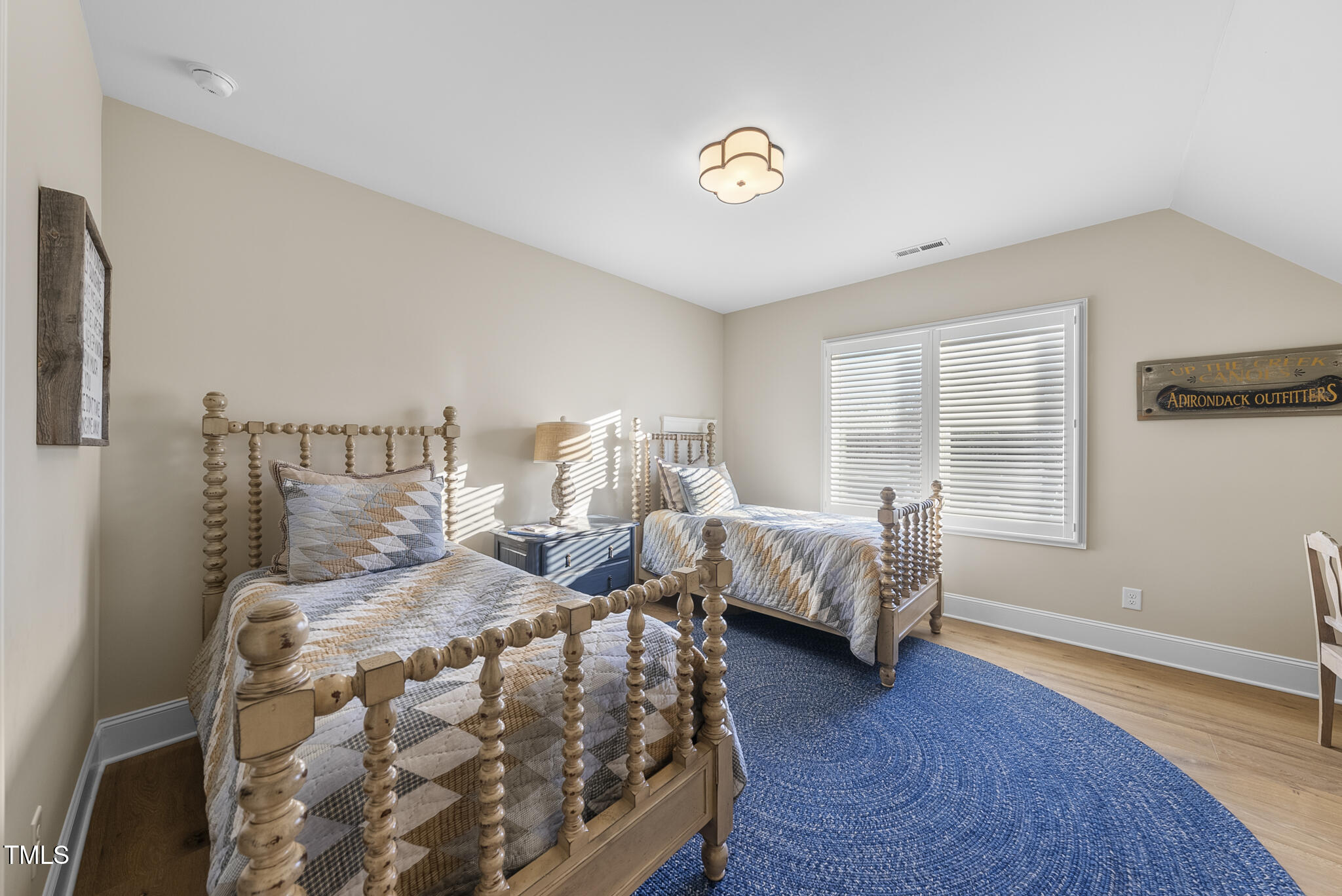 3018 Farrior Road Raleigh, NC 27607 - Photo 28 of 59 a bedroom with a bed and wooden floor