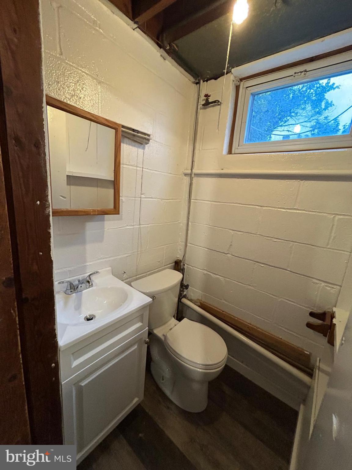4116 Raymonn Avenue Baltimore, MD 21213 - Photo 14 of 16 a white toilet sitting next to a bathroom sink