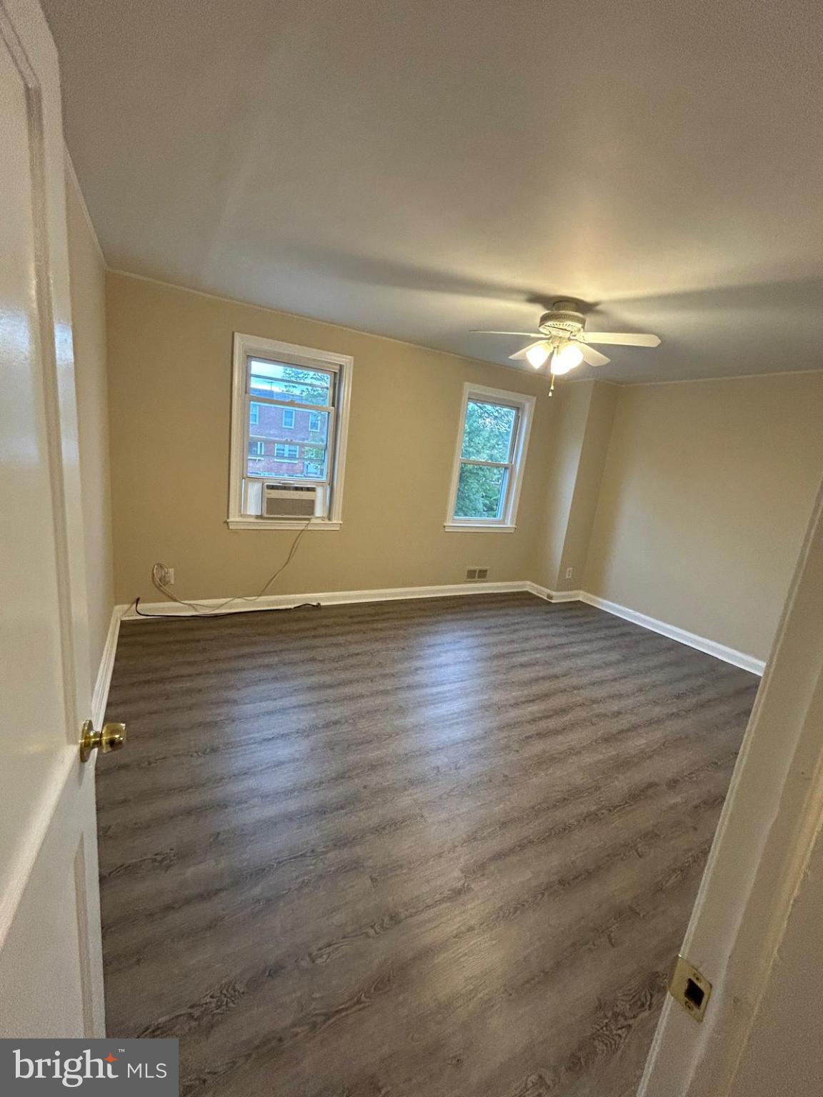 4116 Raymonn Avenue Baltimore, MD 21213 - Photo 8 of 16 an empty room with wooden floor and windows