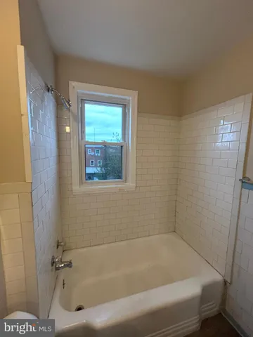 a bathroom with a tub and a shower