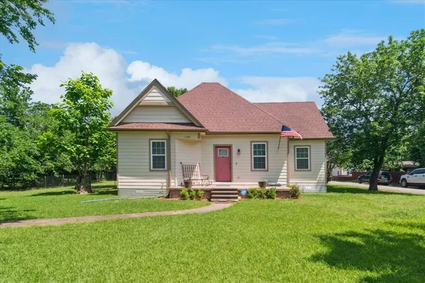 a front view of house with yard and green space