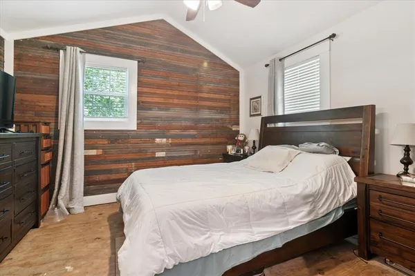 a bedroom with a bed and a flat screen tv