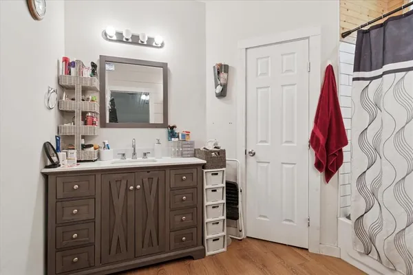 a bathroom with a sink vanity and a mirror