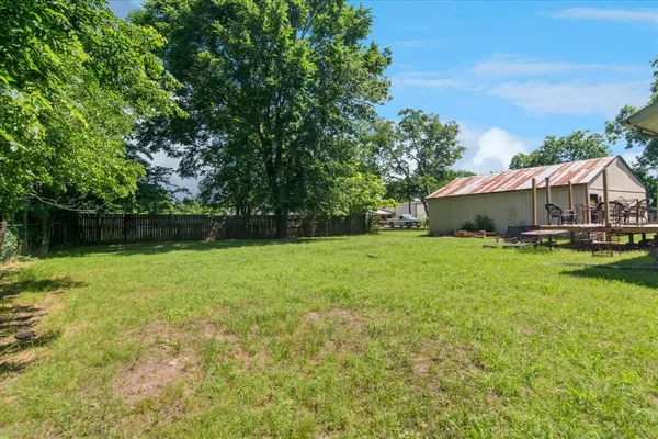 a view of a house with a backyard
