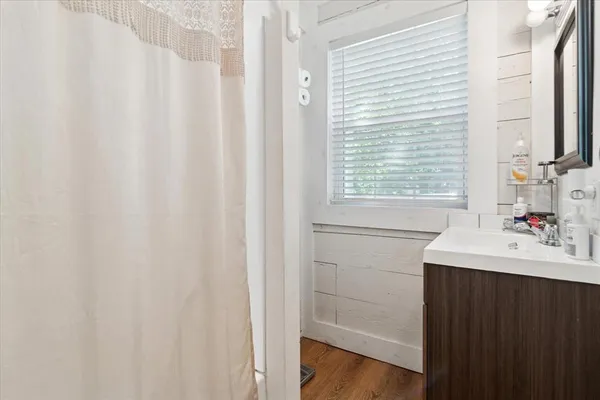 a bathroom with a sink and a window