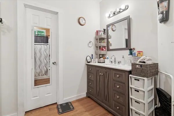 a bathroom with a sink vanity and a mirror