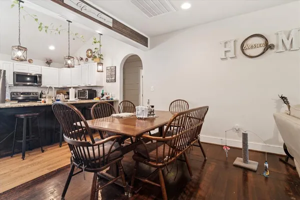 a view of a dining room with furniture and wooden floor