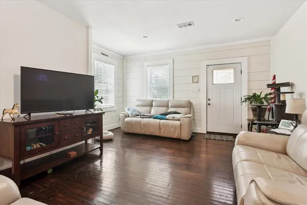 a living room with furniture and a flat screen tv