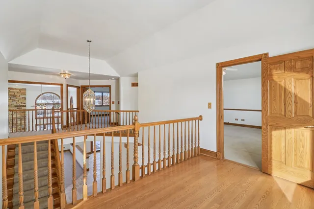 a view of a room with wooden floor and fan
