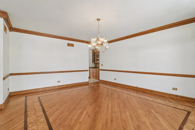 a front view of a house with a yard covered in snow