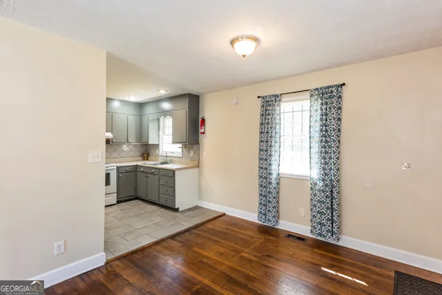 a view of kitchen with sink and wooden floor