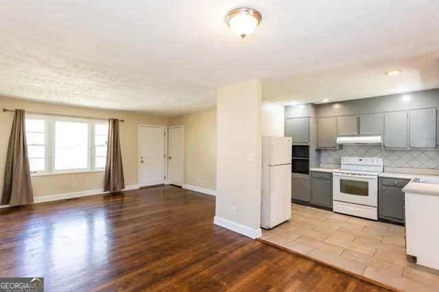 a view of a kitchen with a sink and a stove top oven