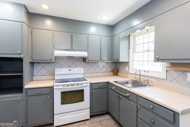 a kitchen with appliances cabinets and a sink