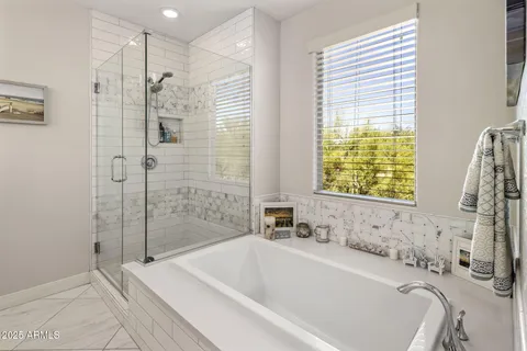 a bathroom with a bathtub and a shower