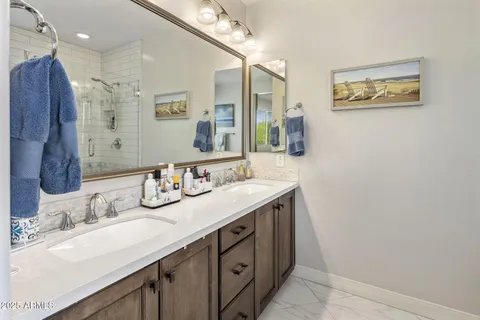 a bathroom with a double vanity sink mirror and double