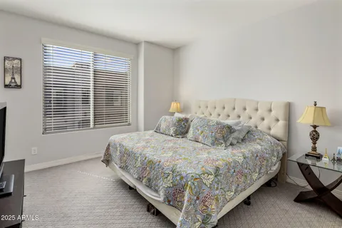 a bedroom with a bed and window