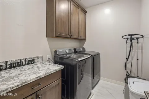 a utility room with faucet sink and cabinets