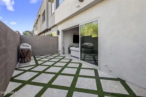 an aerial view of a house with garden space and outdoor seating