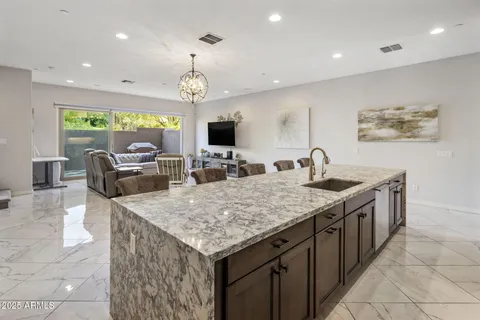 a kitchen with granite countertop a sink a counter top space appliances and cabinets