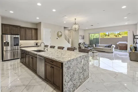 a kitchen with stainless steel appliances granite countertop a sink counter space cabinets and a large window