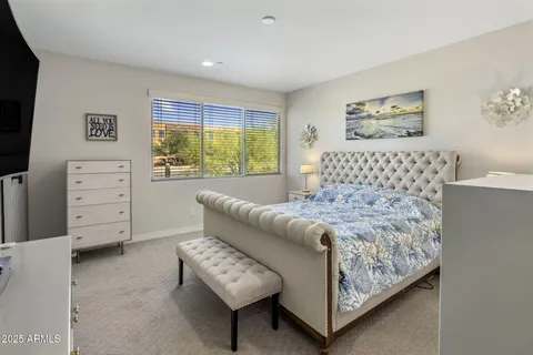 a bedroom with a bed and dresser