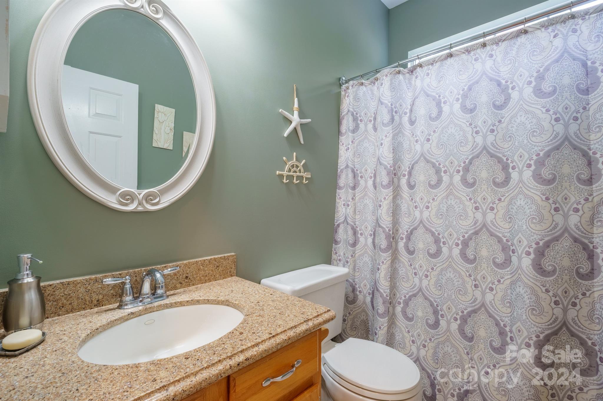 7401 Reedy Creek Road Charlotte, NC 28215 - Photo 17 of 25 a bathroom with a granite countertop toilet sink and mirror