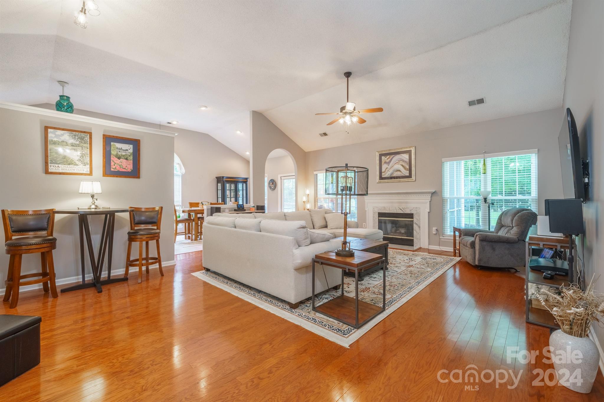 7401 Reedy Creek Road Charlotte, NC 28215 - Photo 4 of 25 a living room with fireplace furniture and a wooden floor