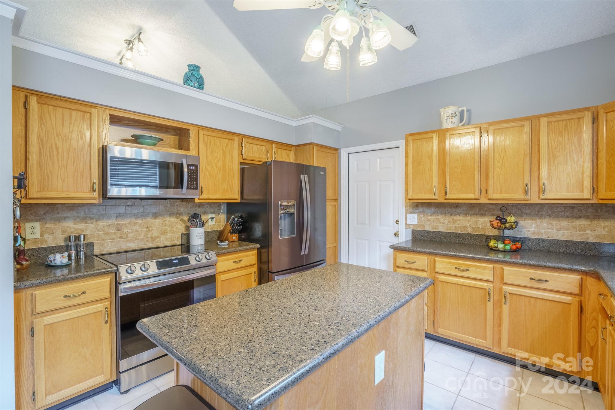 7401 Reedy Creek Road Charlotte, NC 28215 - Photo 6 of 25 a kitchen with stainless steel appliances granite countertop stove microwave and refrigerator