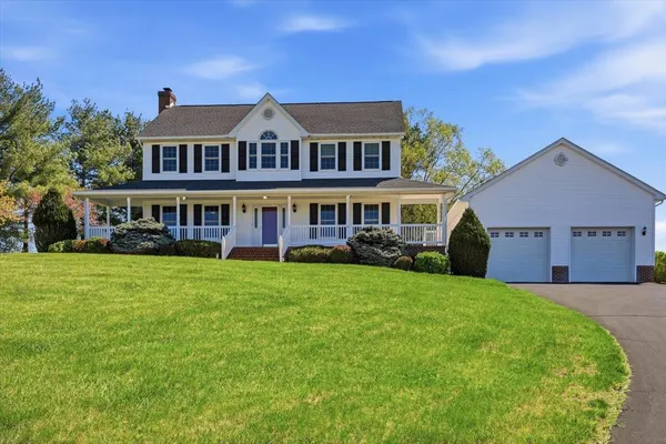 a front view of a house with a garden and yard