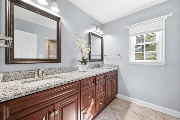 a bathroom with a toilet a sink a mirror and vanity