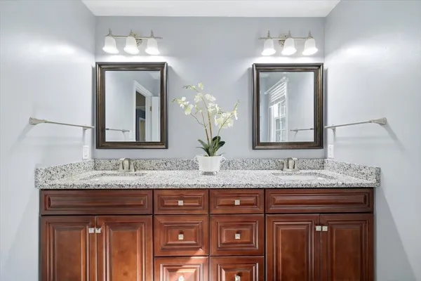an aerial view of a house with a garden and lake view
