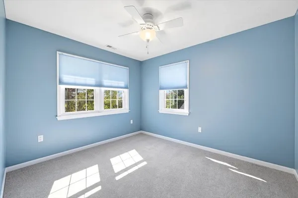 an aerial view of houses with a yard