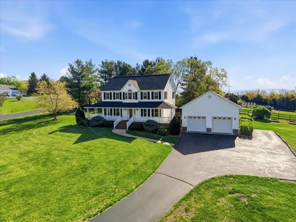 a view of a yard with plants and sitting area