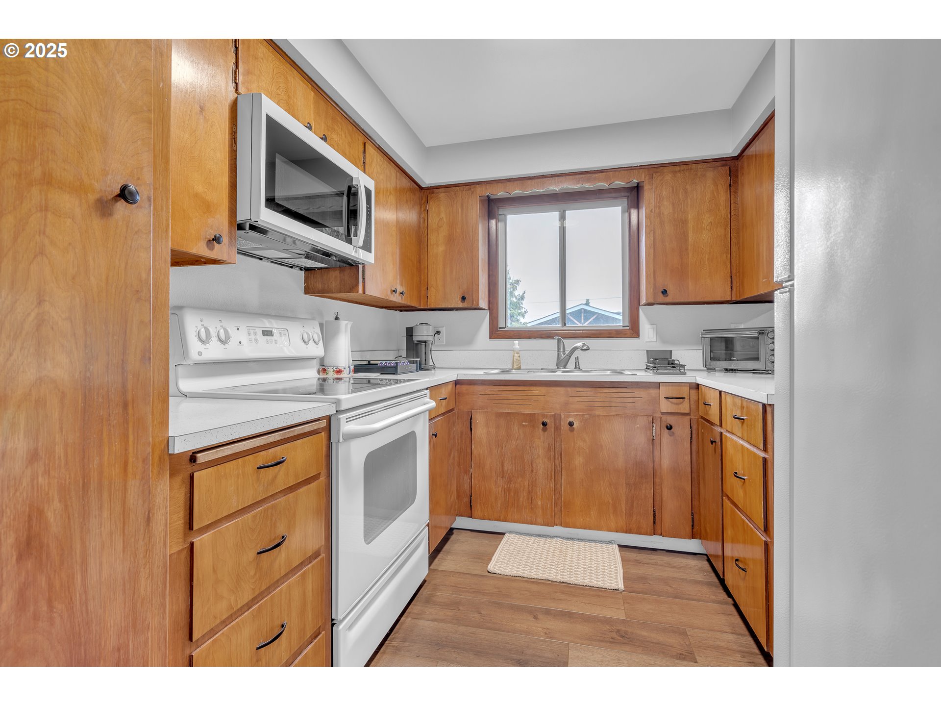 3472 Hoodview Drive Hubbard, OR 97032 - Photo 7 of 23 a kitchen with stainless steel appliances granite countertop a stove a sink and a microwave