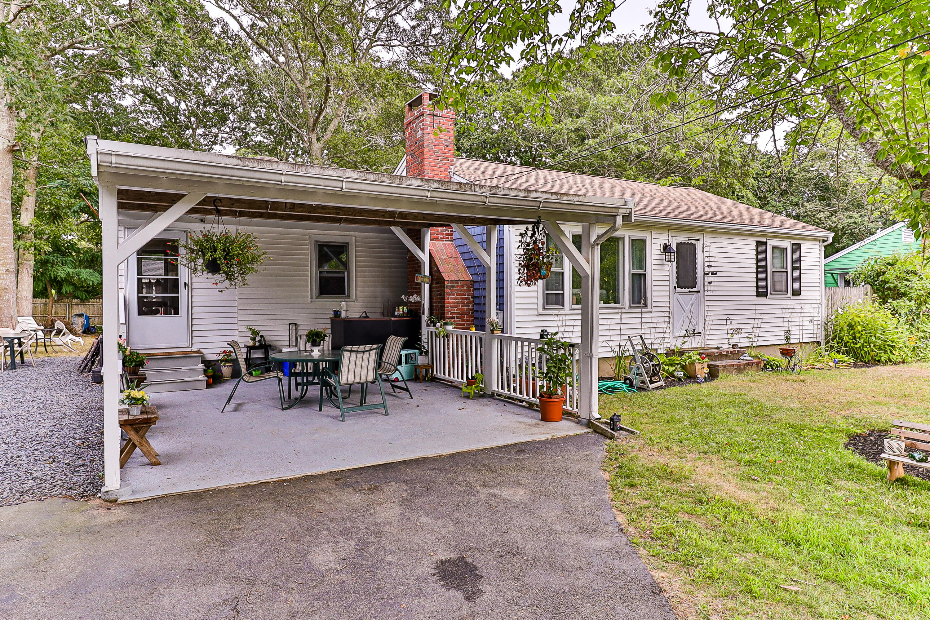 440 Lincoln Rd Extension Barnstable, MA 02601 - Photo 2 of 19 a view of a patio with table and chairs under an umbrella