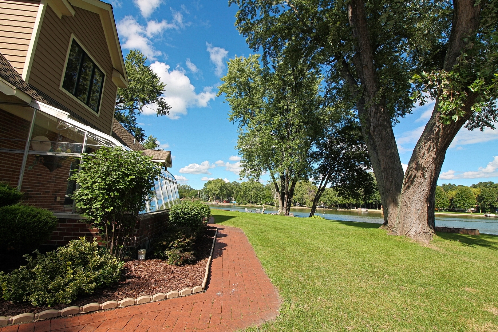 4444 Riverside Drive Crystal Lake, IL 60014 - Photo 23 of 30 a view of a yard with plants and a large tree