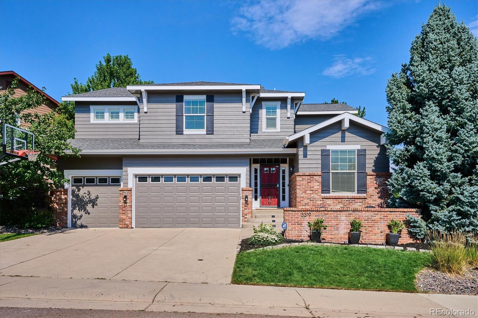 3319 Lynwood Avenue Highlands Ranch, CO 80126 - Photo 1 of 46 a front view of a house with a yard and garage