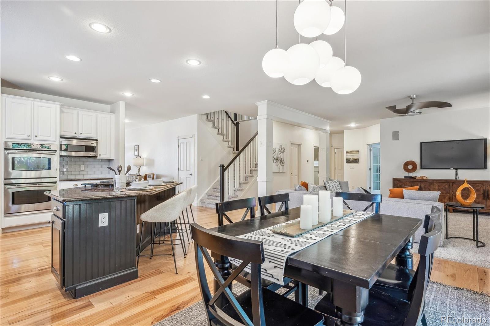 3319 Lynwood Avenue Highlands Ranch, CO 80126 - Photo 11 of 46 a view of a dining room with furniture and wooden floor