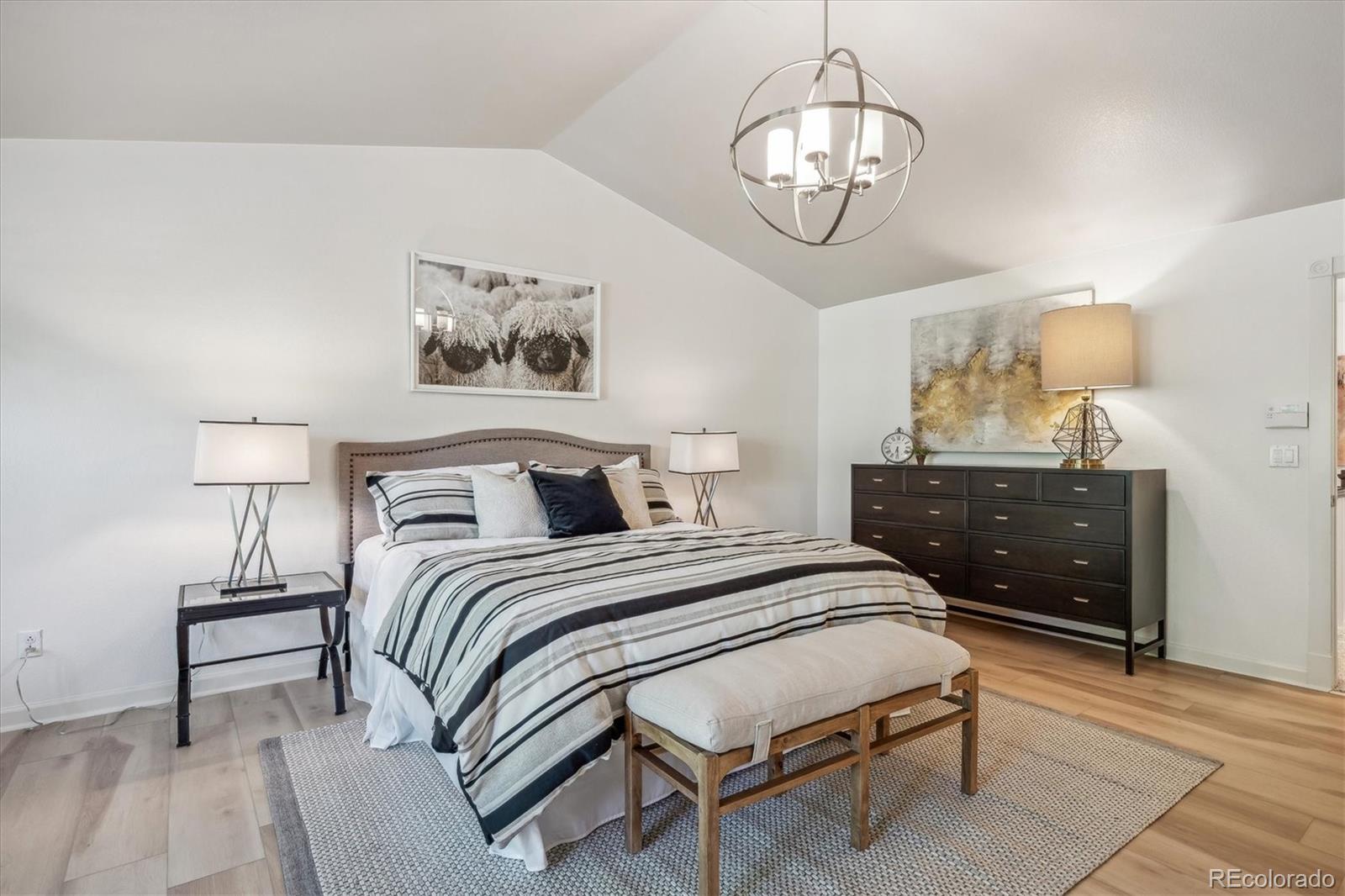 3319 Lynwood Avenue Highlands Ranch, CO 80126 - Photo 20 of 46 a spacious bedroom with a bed and a table