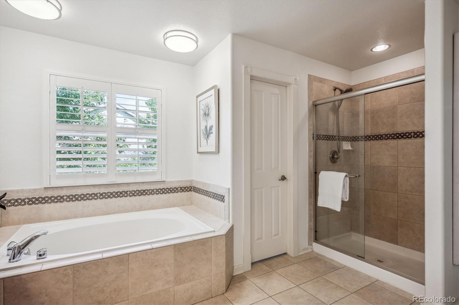 3319 Lynwood Avenue Highlands Ranch, CO 80126 - Photo 22 of 46 a bathroom with a bathtub and a shower
