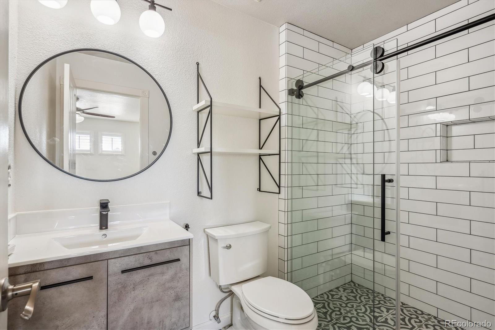 3319 Lynwood Avenue Highlands Ranch, CO 80126 - Photo 23 of 46 a bathroom with a sink a toilet and a mirror