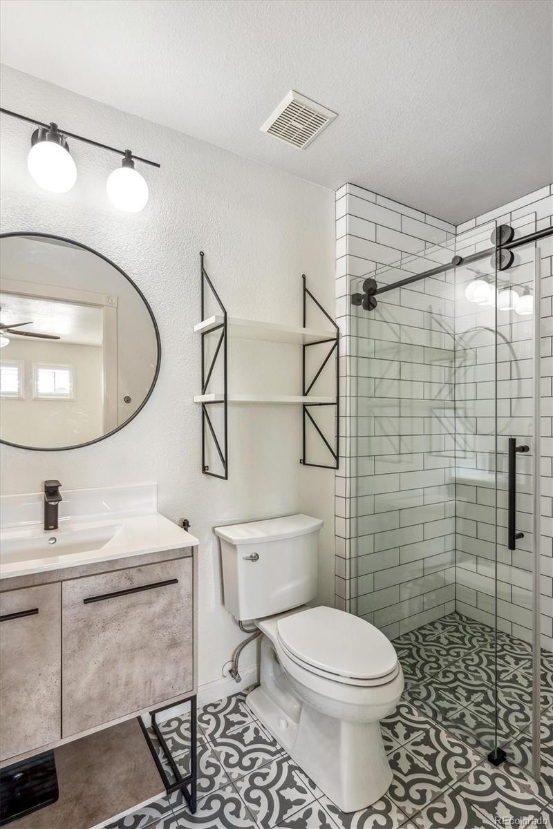 3319 Lynwood Avenue Highlands Ranch, CO 80126 - Photo 24 of 46 a bathroom with a toilet a sink and mirror