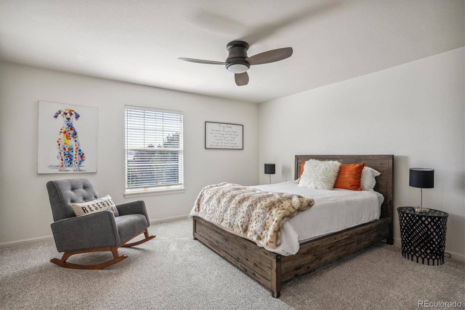 3319 Lynwood Avenue Highlands Ranch, CO 80126 - Photo 25 of 46 a spacious bedroom with a bed and a couch