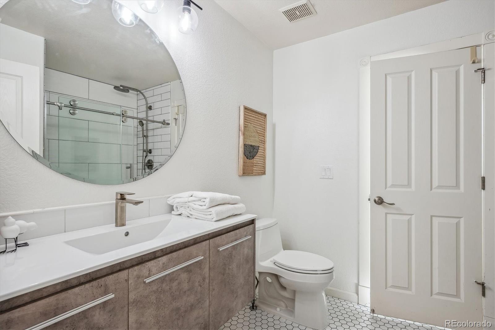3319 Lynwood Avenue Highlands Ranch, CO 80126 - Photo 28 of 46 a bathroom with a sink a toilet and shower
