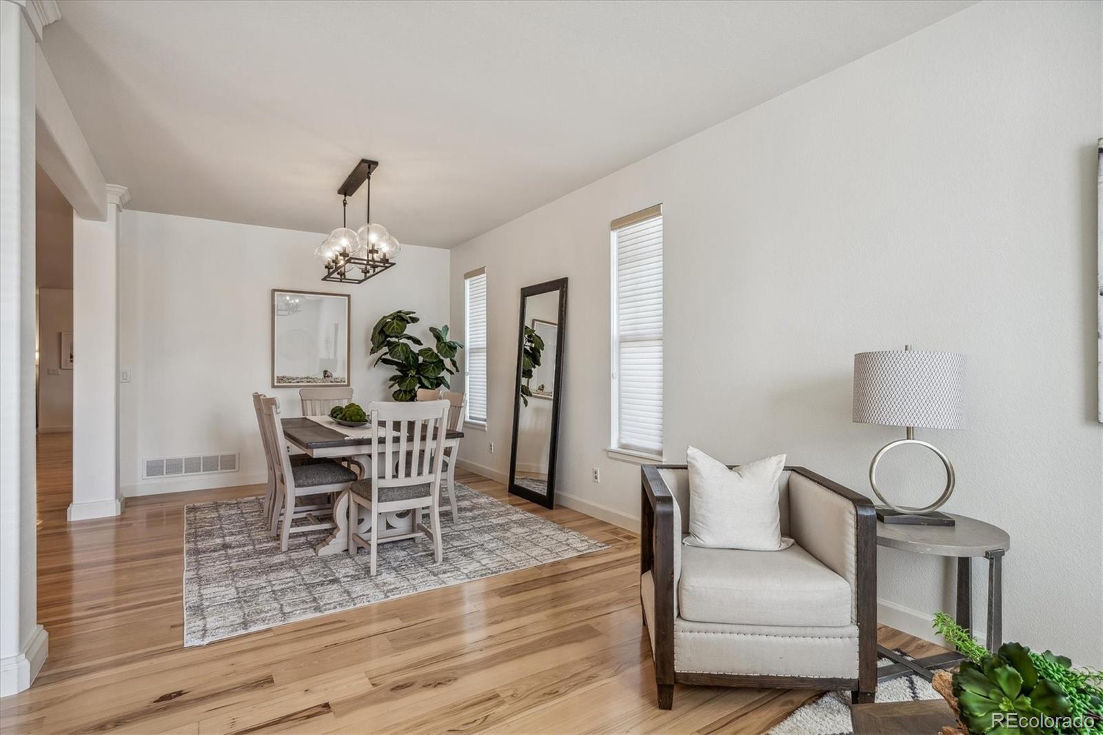 3319 Lynwood Avenue Highlands Ranch, CO 80126 - Photo 4 of 46 a view of a dining room with furniture and wooden floor