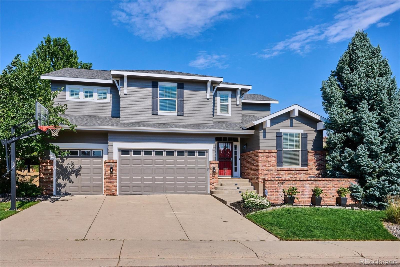 3319 Lynwood Avenue Highlands Ranch, CO 80126 - Photo 41 of 46 a front view of a house with a yard