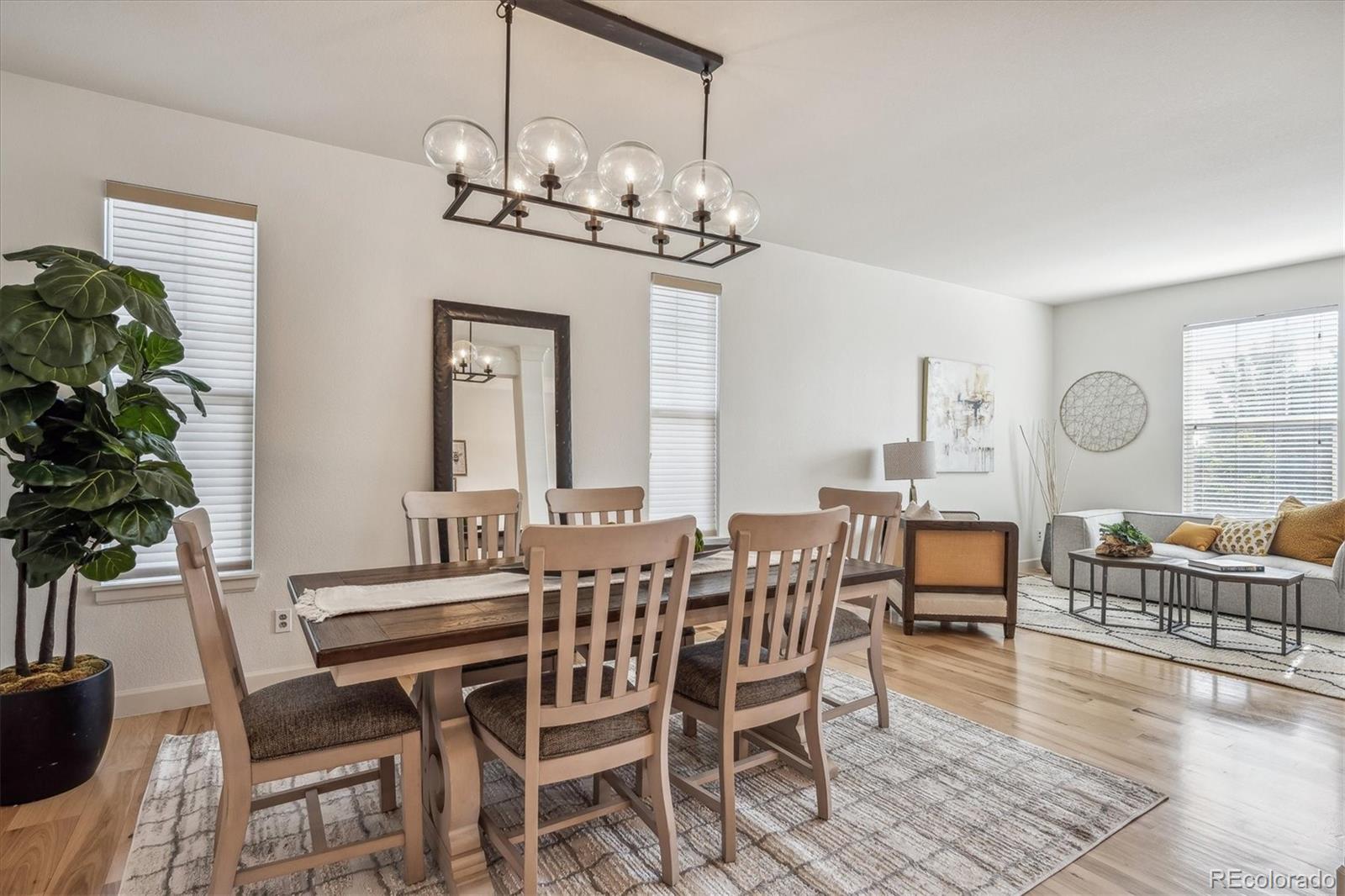 3319 Lynwood Avenue Highlands Ranch, CO 80126 - Photo 6 of 46 a view of a dining room with furniture wooden floor and chandelier