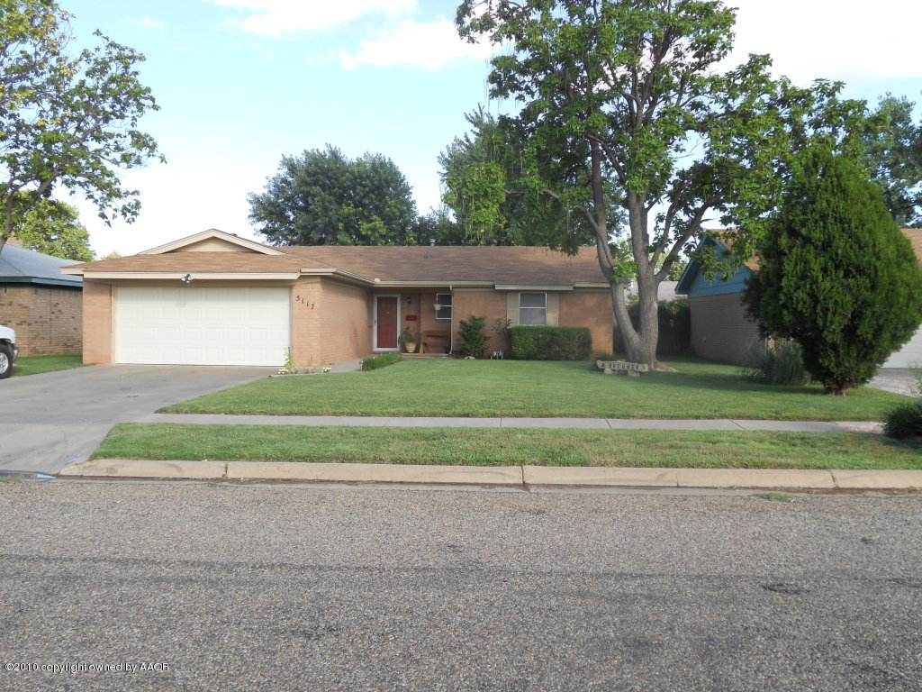 5117 McCarty Boulevard Amarillo, TX 79110 - Photo 1 of 17 a view of a house with a yard and large trees